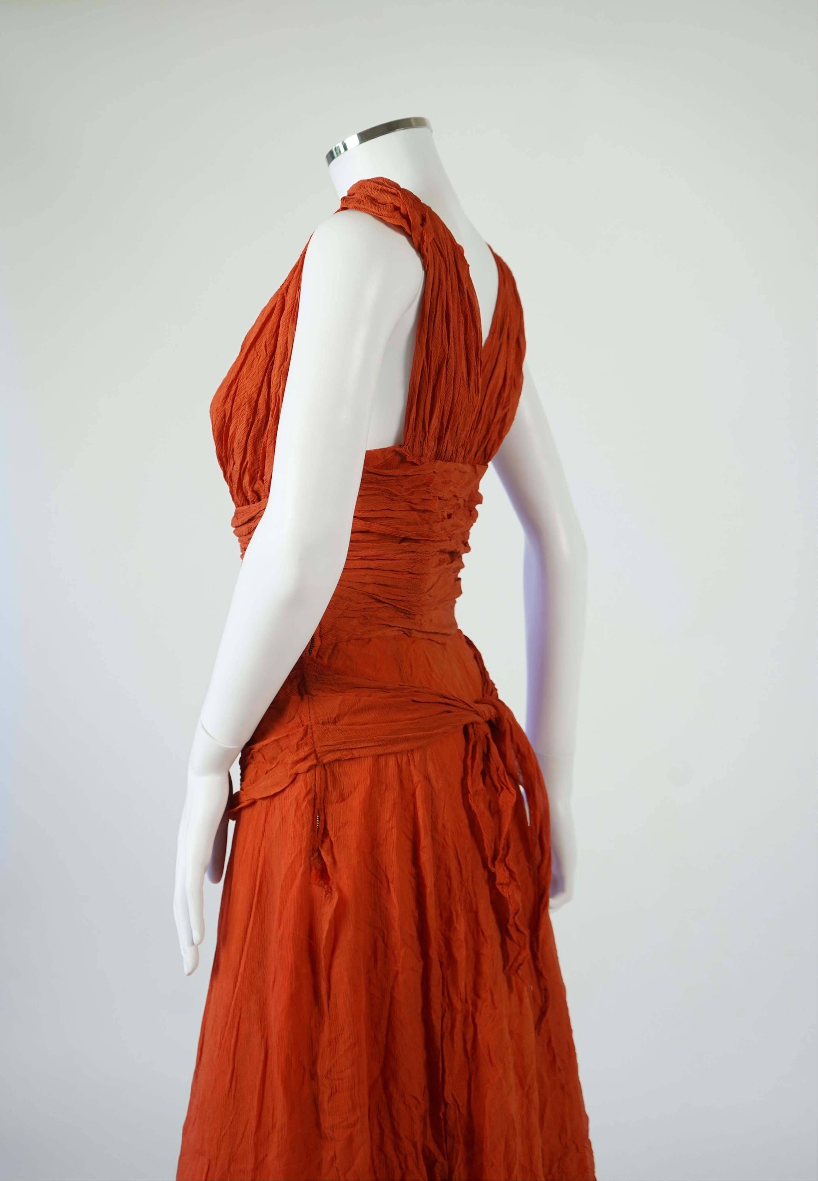 A 1940’s orange chiffon evening dress, with an orange silk taffeta lining, a pleated bodice and front apron panel tied at the back., 156 cm long. Condition - there are a few small holes in the chiffon at the back of the
